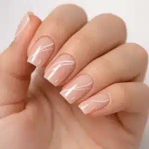 Manicura minimalista en uñas coffin cortas a medianas con esmalte nude y acabado gel ultra brillante, diseño elegante de líneas finas blancas, fotografía macro profesional estilo estudio premium.
